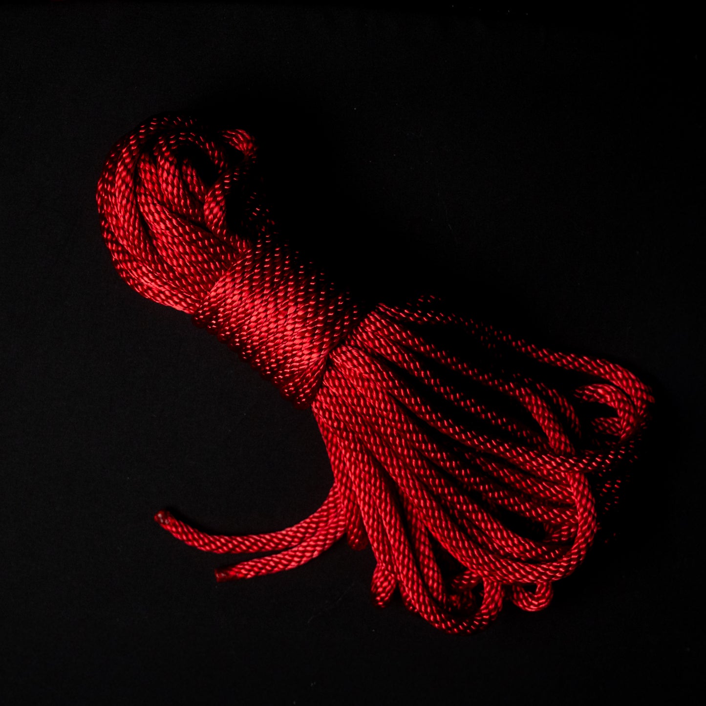 50 ft nylon rope bundle in Ritual Red, a dark crimson rope with a deep ruby glow, balancing warmth and intensity like candlelight reflected on ritual silk.