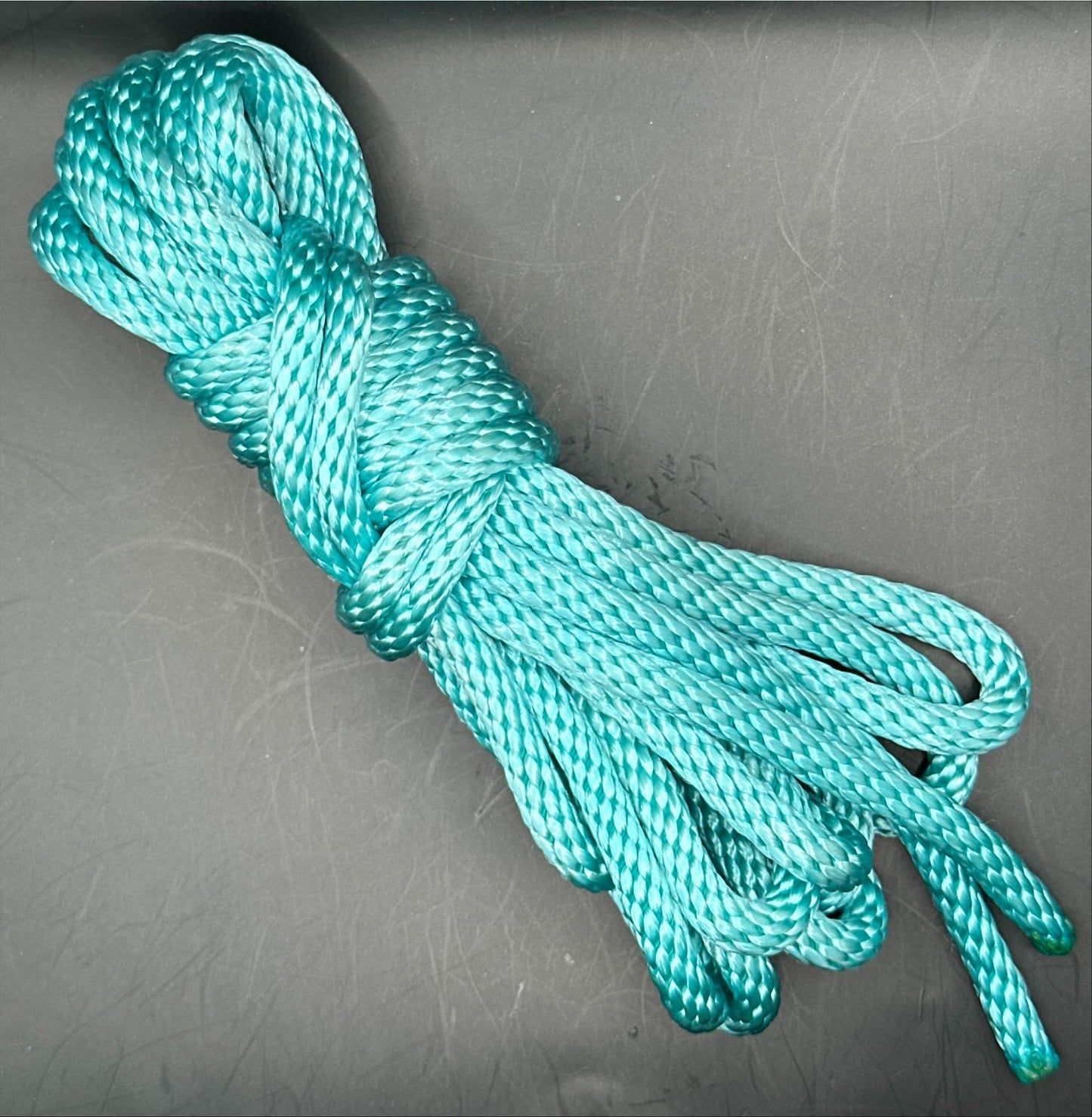 15 ft nylon rope bundle in AquaKnot, a neon water blue glowing with vibrant aquatic shimmer under UV light.