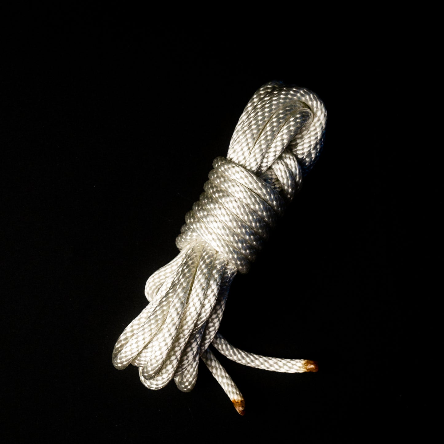 15 ft nylon rope bundle in Lunar Light White, a glossy rope with a pearlescent sheen that shimmers like moonlight — softly iridescent and glowing with a celestial radiance under UV light.