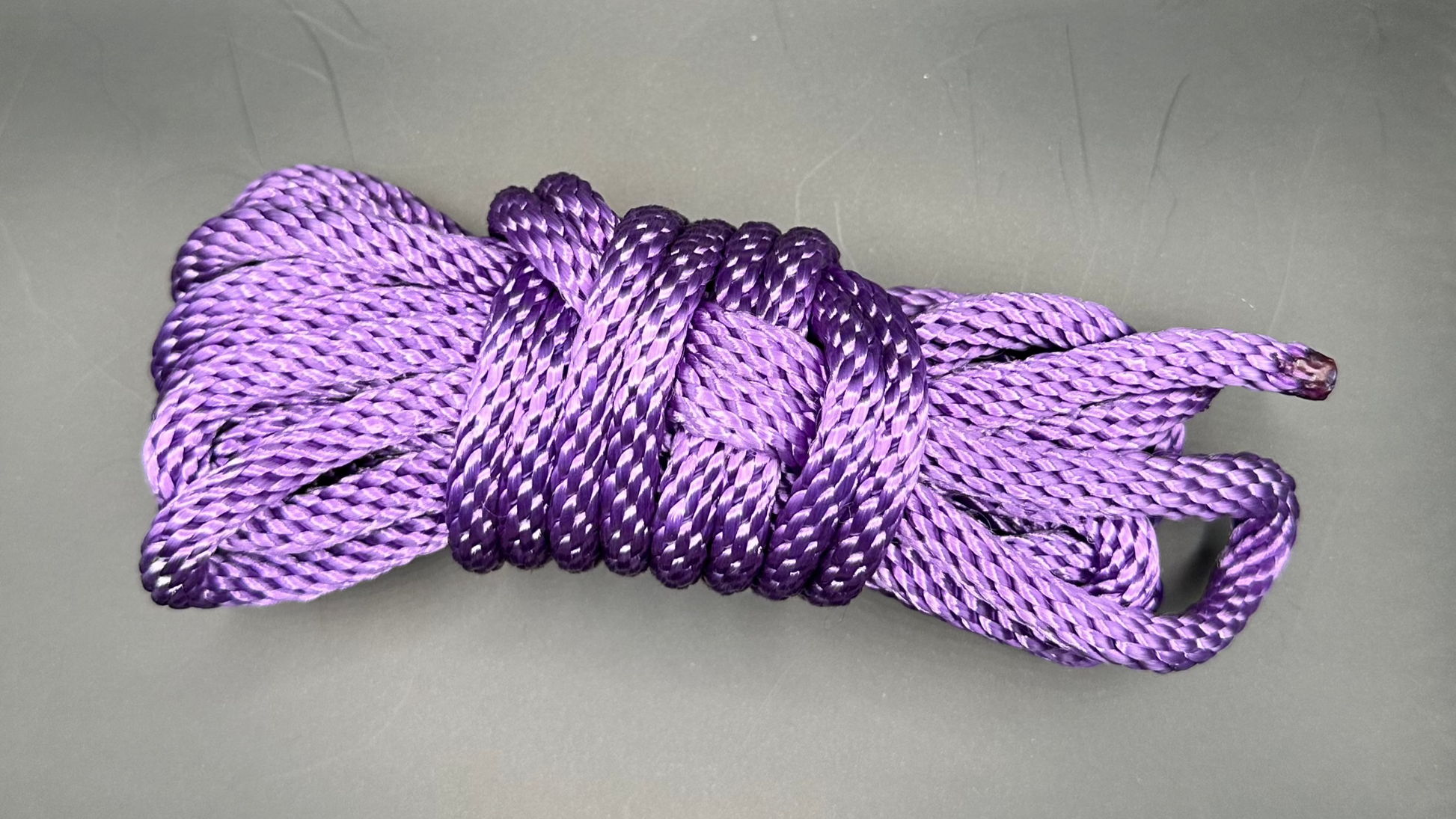 15 ft nylon rope bundle in Purple Passion, a vibrant royal purple with cool blue undertones that glows a bold, electric violet under UV light — rich, radiant, and unmistakably alive.