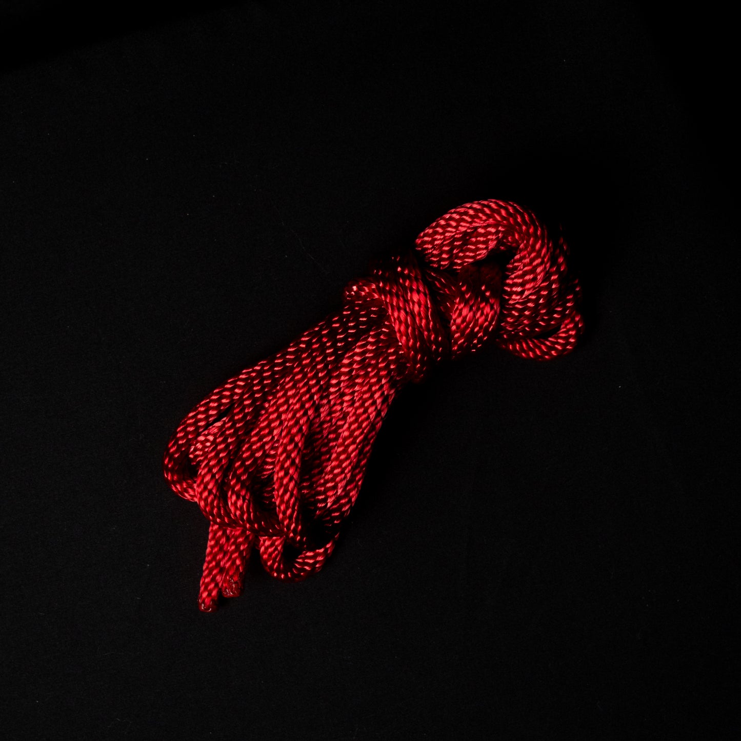 15 ft nylon rope bundle in Ritual Red, a dark crimson rope with a deep ruby glow, balancing warmth and intensity like candlelight reflected on ritual silk.