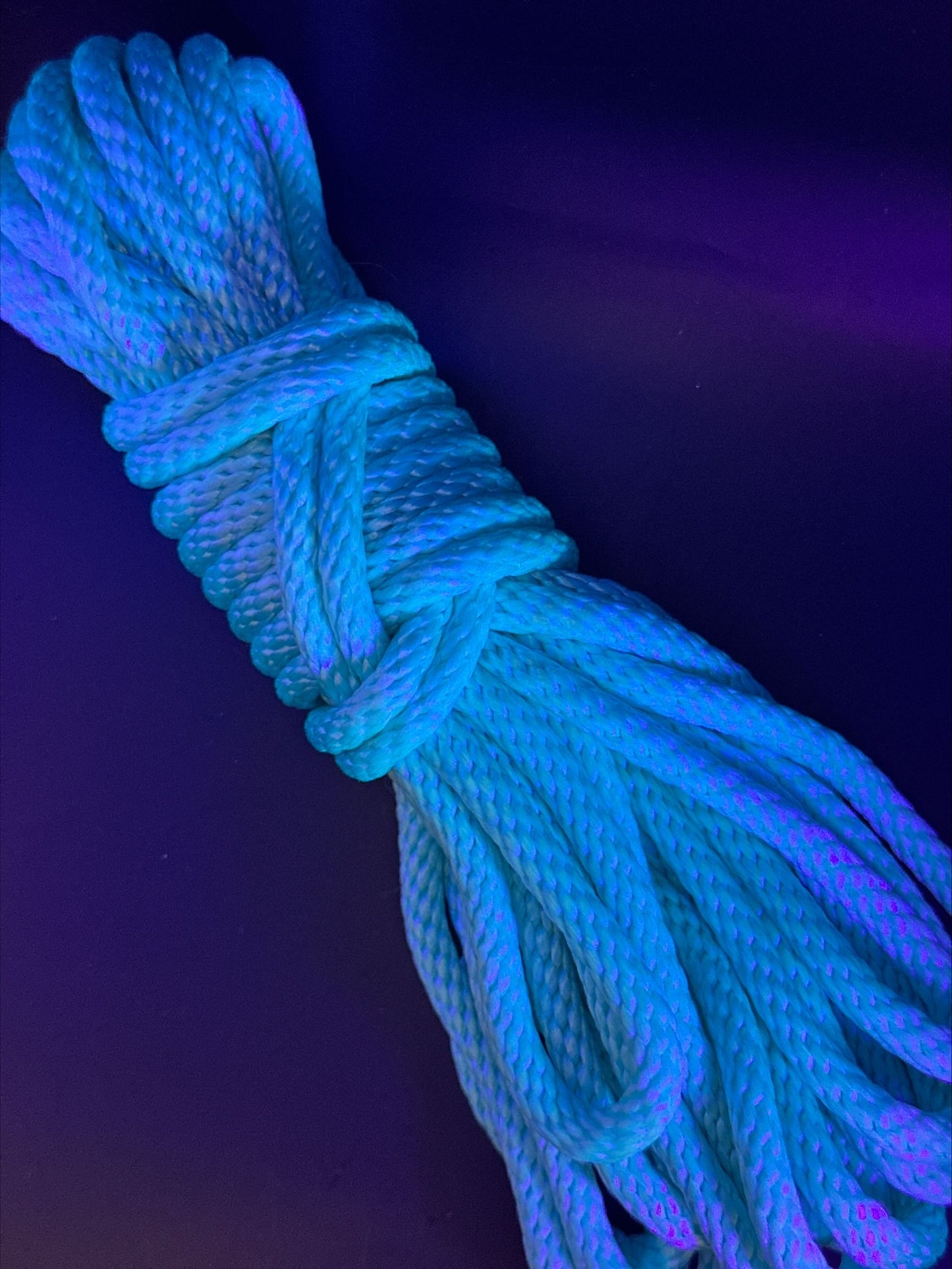 30 ft nylon rope bundle in AquaKnot, a neon water blue glowing with vibrant aquatic shimmer under UV light.