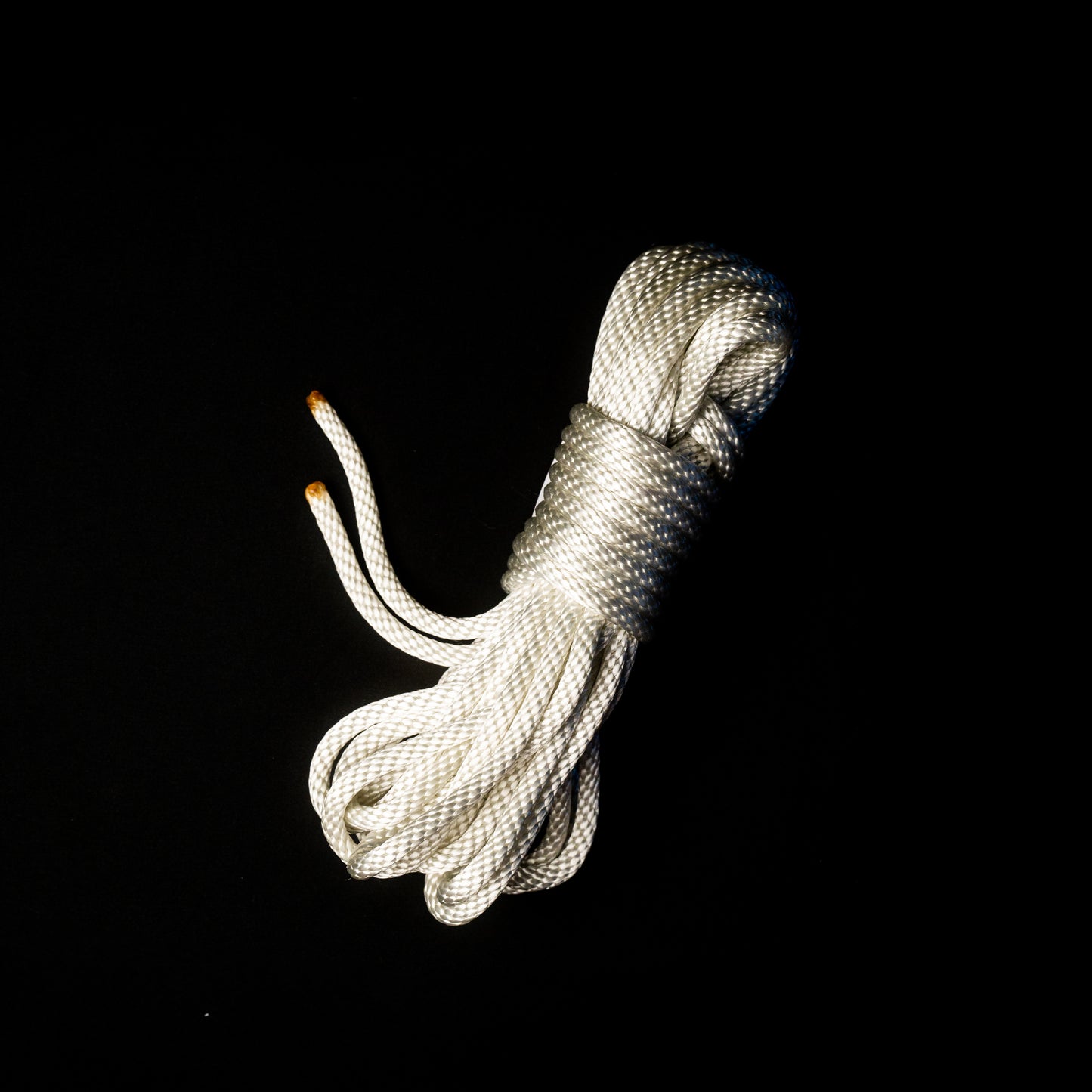 30 ft nylon rope bundle in Lunar Light White, a glossy rope with a pearlescent sheen that shimmers like moonlight — softly iridescent and glowing with a celestial radiance under UV light.