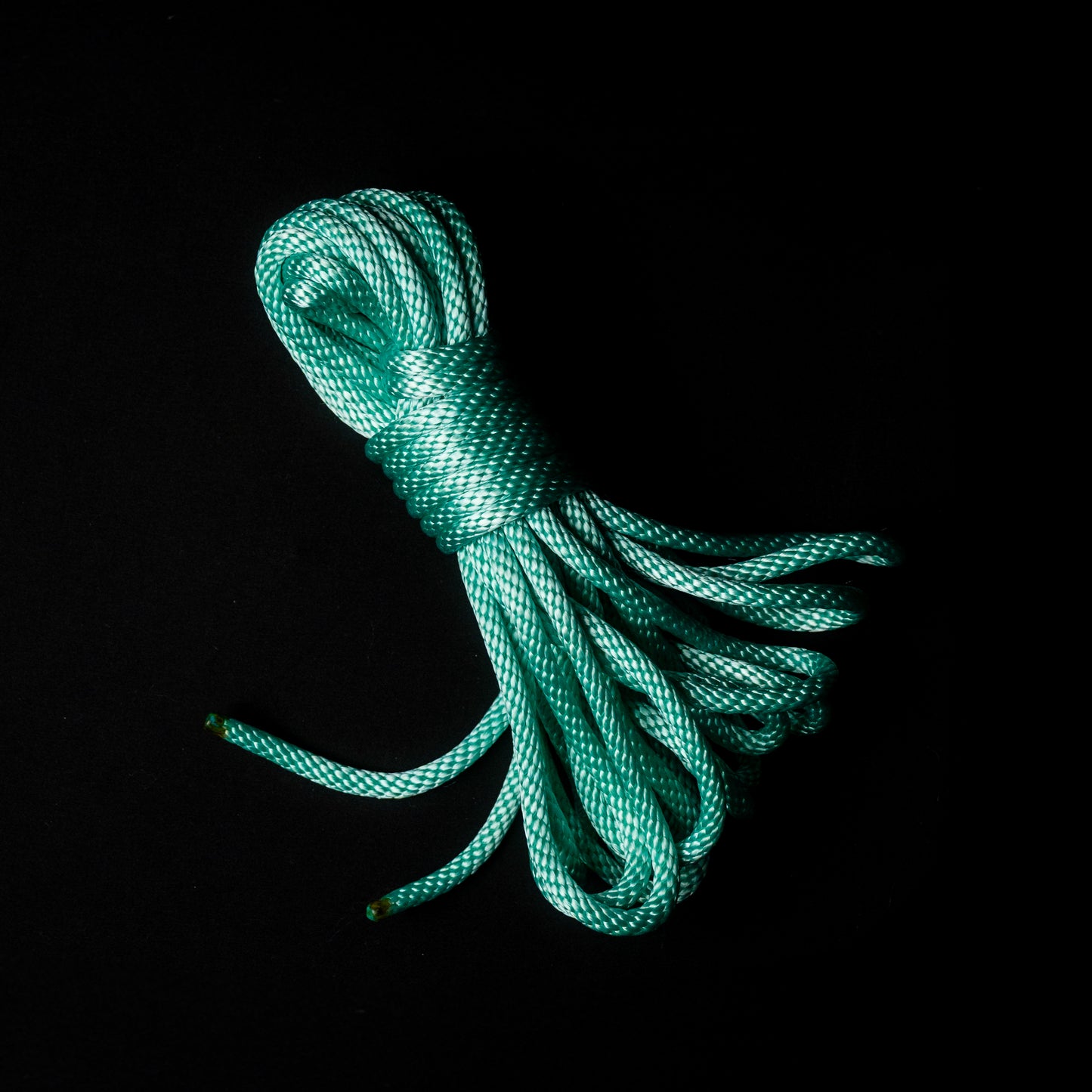 30 ft nylon rope bundle in Mermaid Mint — a luminous seafoam green rope that glows like enchanted ocean light under blacklight.