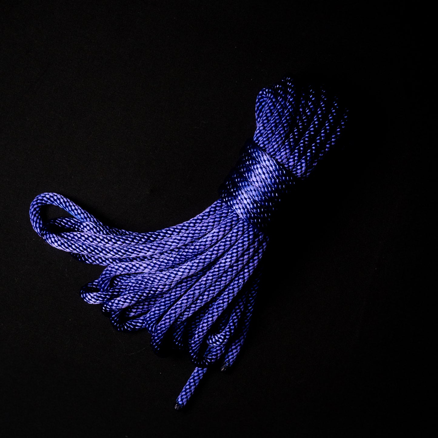 30 ft nylon rope bundle in Midnight Plum, a deep plum–indigo nylon rope with cool lilac undertones that glows with a dark, moody indigo radiance under UV light, evoking the mystery of midnight skies.