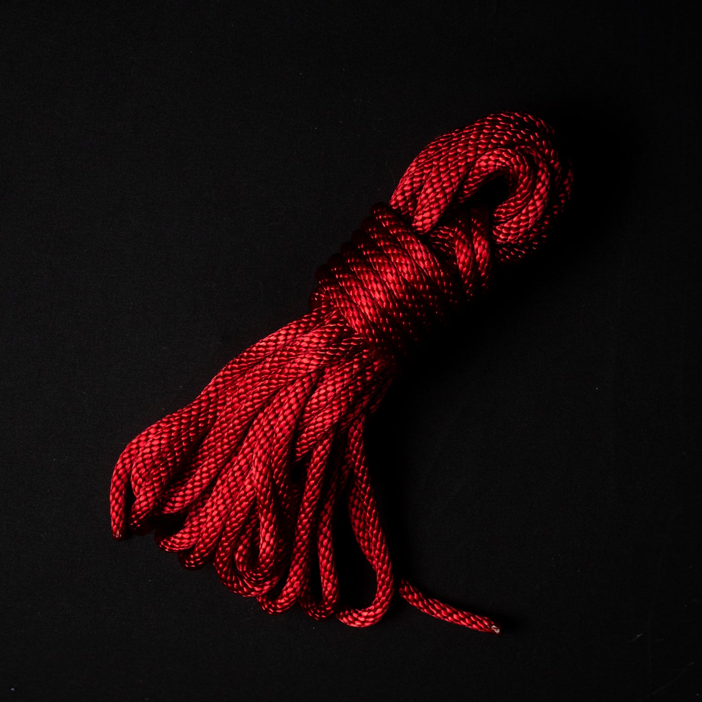 30 ft nylon rope bundle in Ritual Red, a dark crimson rope with a deep ruby glow, balancing warmth and intensity like candlelight reflected on ritual silk.