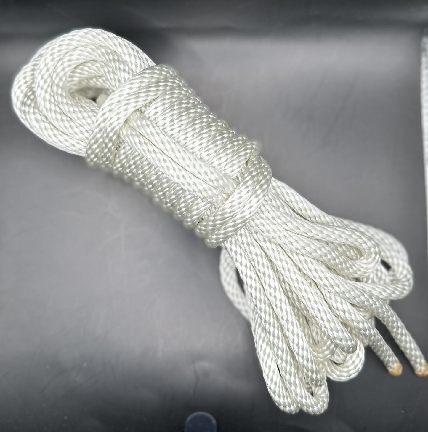 30 ft nylon rope bundle in basic white, with a lovely iridescence from the shiny nylon rope.
