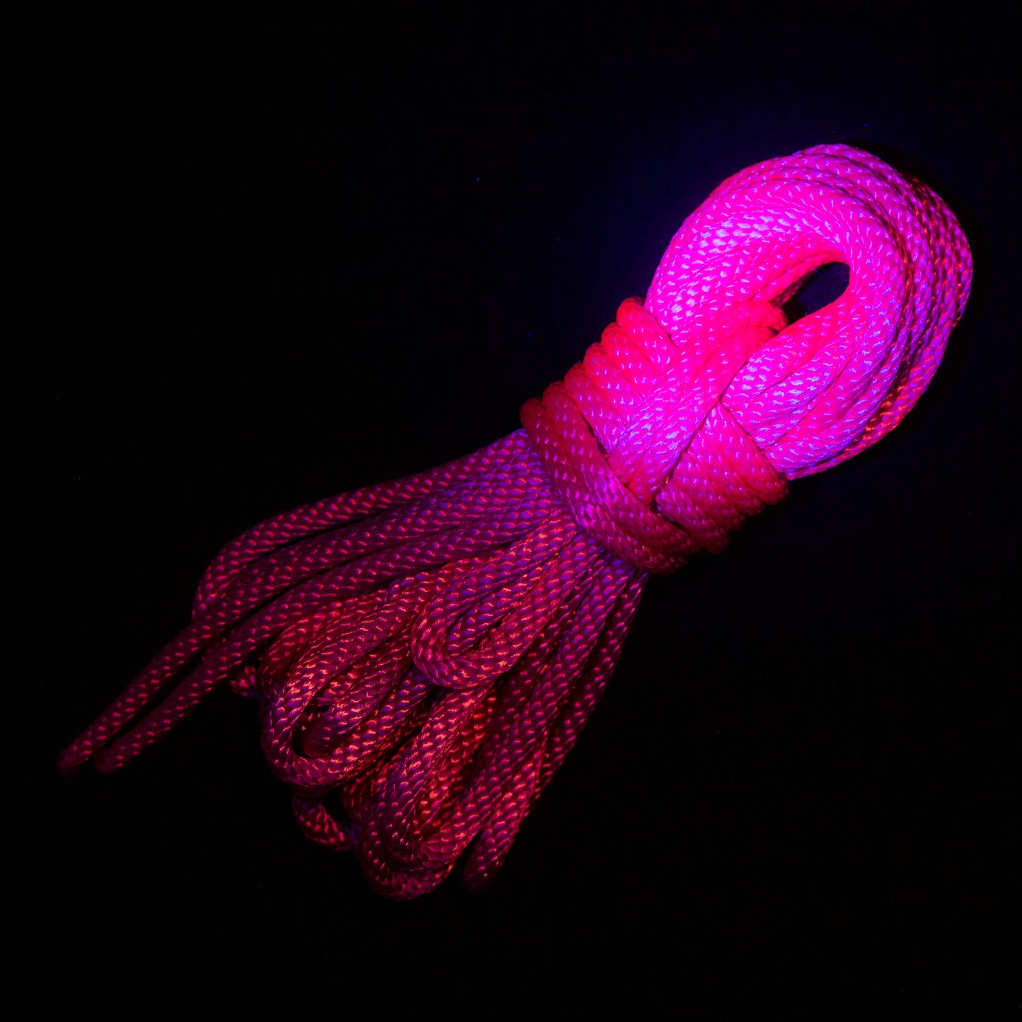 30 ft nylon rope bundle in Pink Pleasure, a bright hot pink with cool undertones, glowing bright hot pink under a black light/uv light. 
