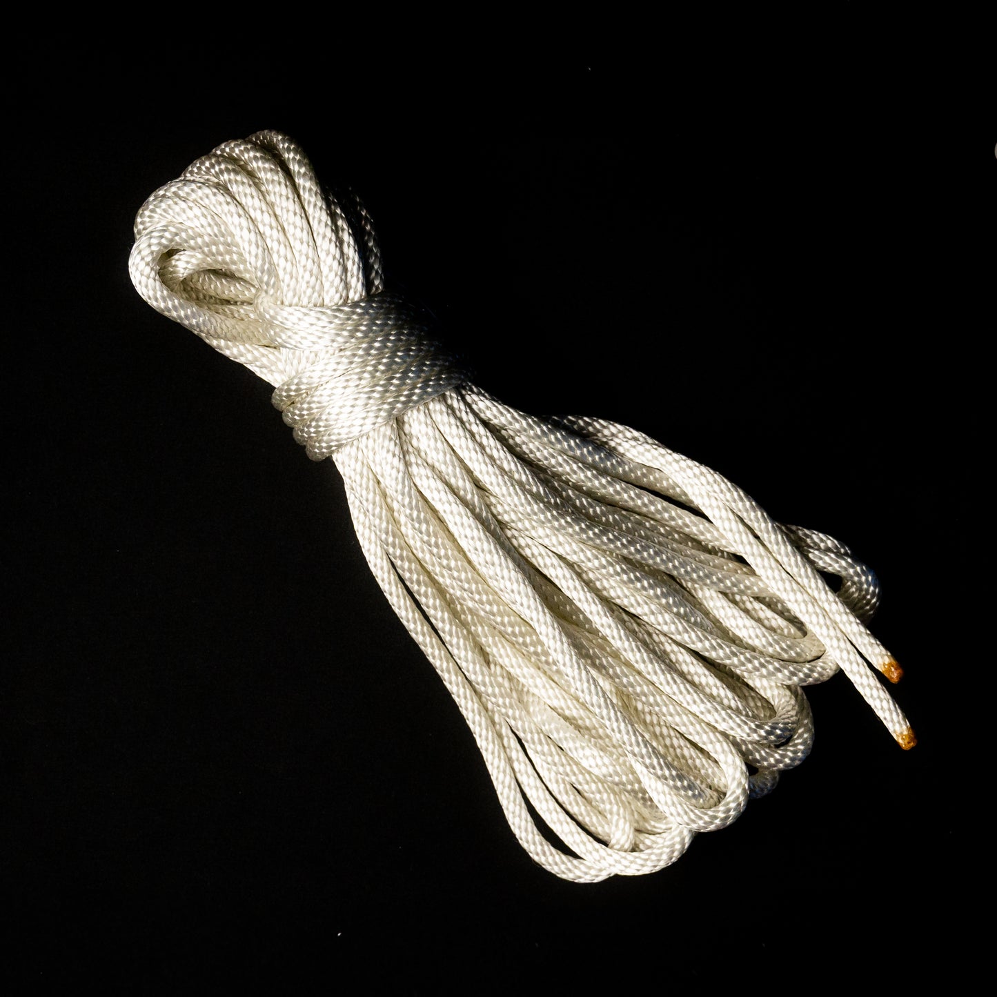 50 ft nylon rope bundle in Lunar Light White, a glossy rope with a pearlescent sheen that shimmers like moonlight — softly iridescent and glowing with a celestial radiance under UV light.