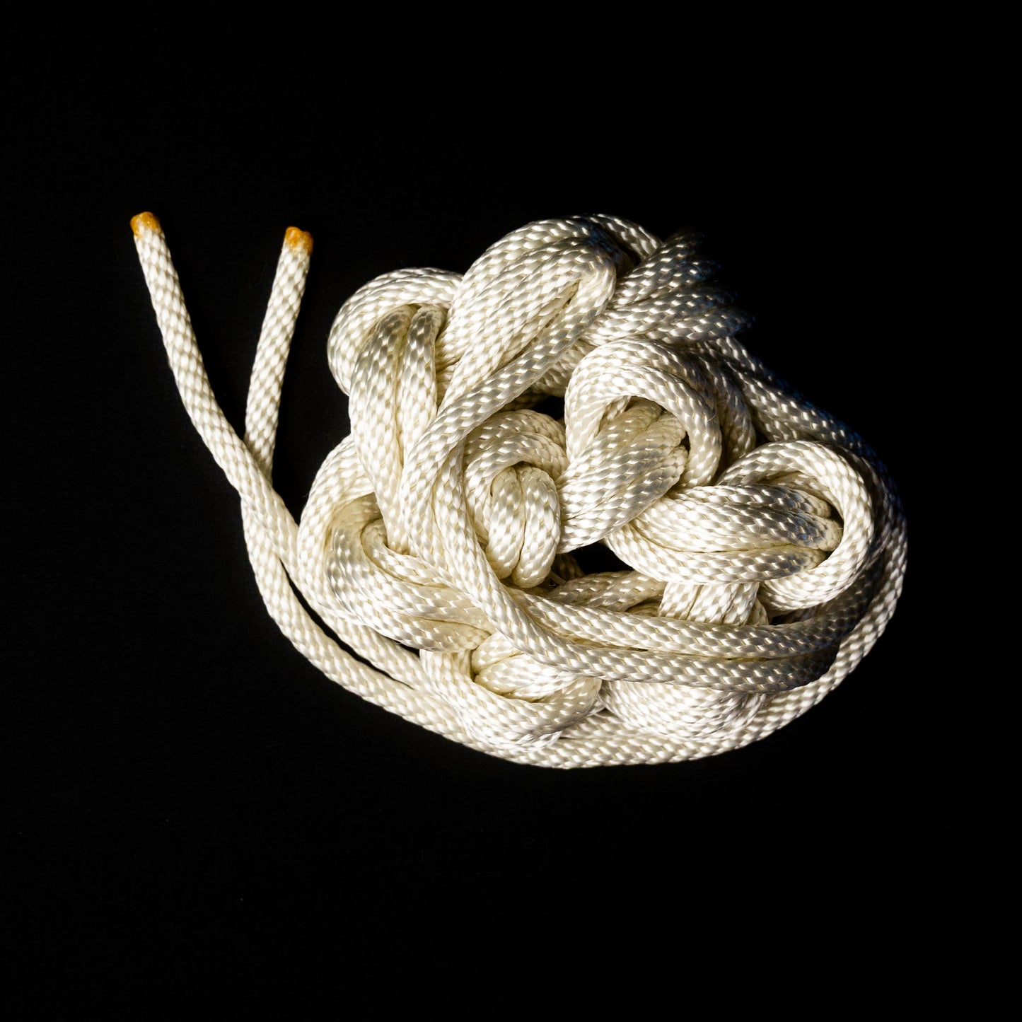 30 ft nylon rope bundle with minor manufacturing imperfections in Lunar Light White, a glossy rope with a pearlescent sheen that shimmers like moonlight — softly iridescent and glowing with a celestial radiance under UV light.