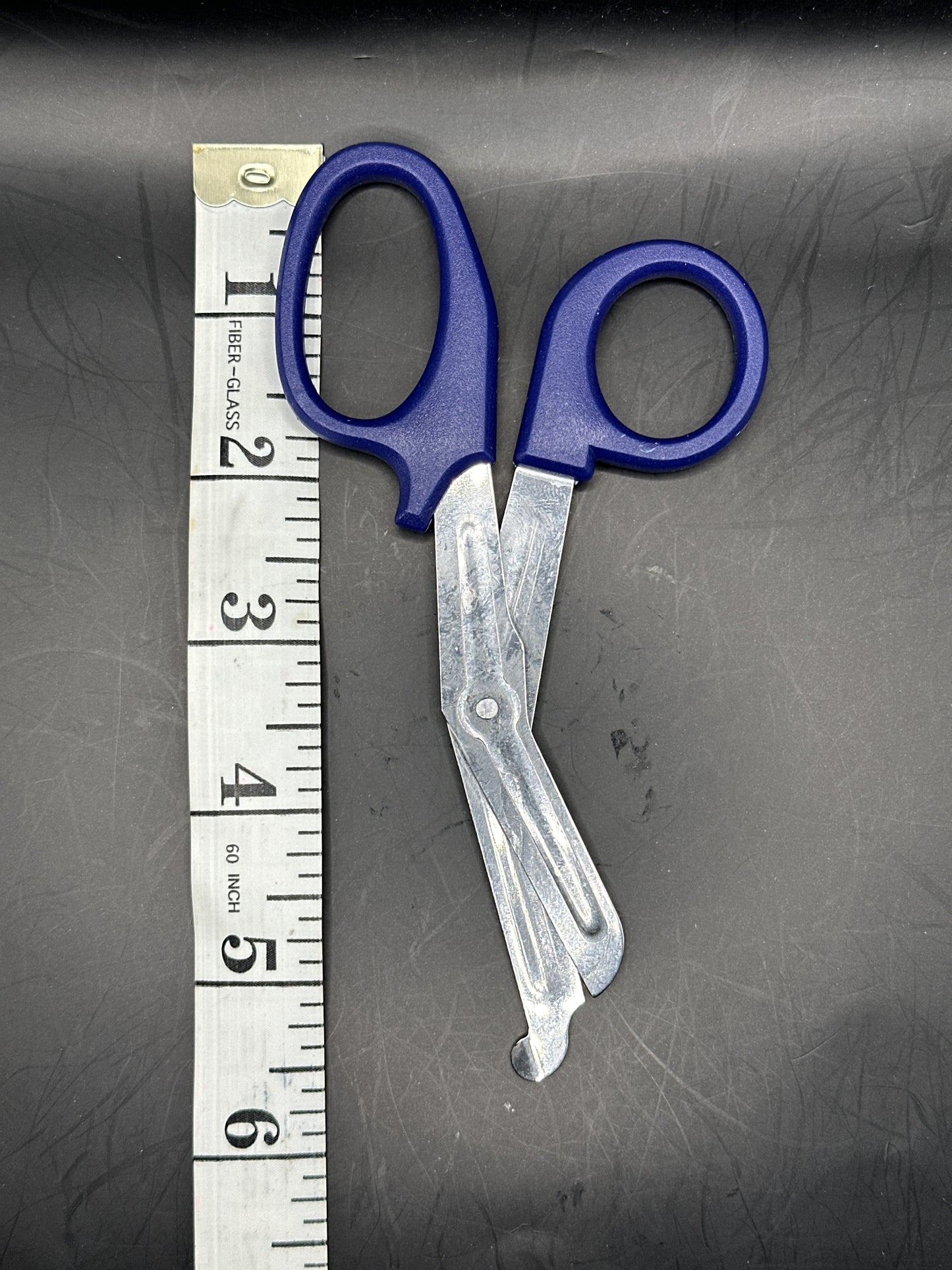 Emergency Scissors/Safety Shears: This Dark Blue pair is 5.7" long, made with stainless steel and designed for first aid use to cut through thicker materials - it works on our rope, we tried it! 