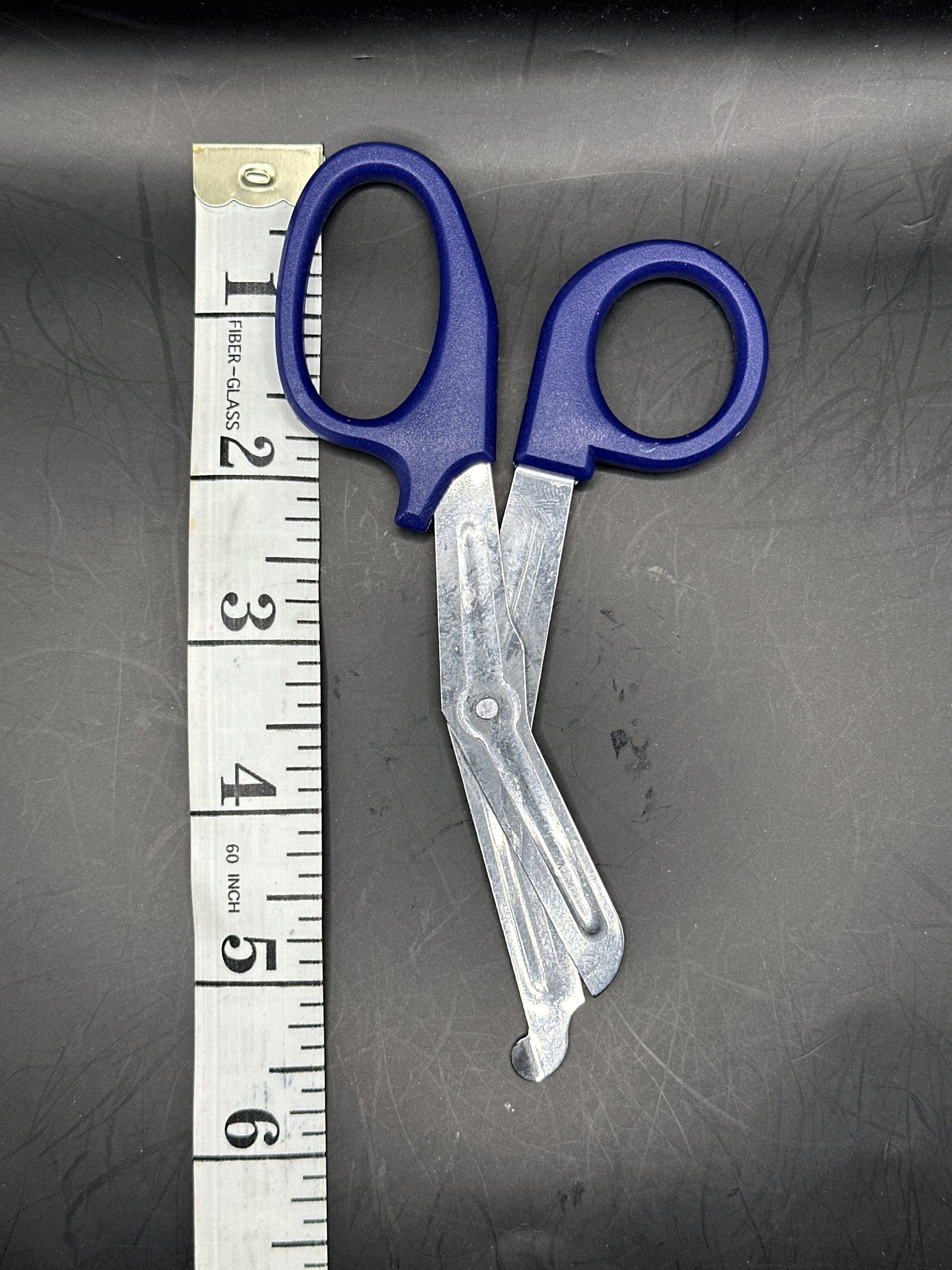 Emergency Scissors/Safety Shears: This Dark Blue pair is 5.7" long, made with stainless steel and designed for first aid use to cut through thicker materials - it works on our rope, we tried it! 