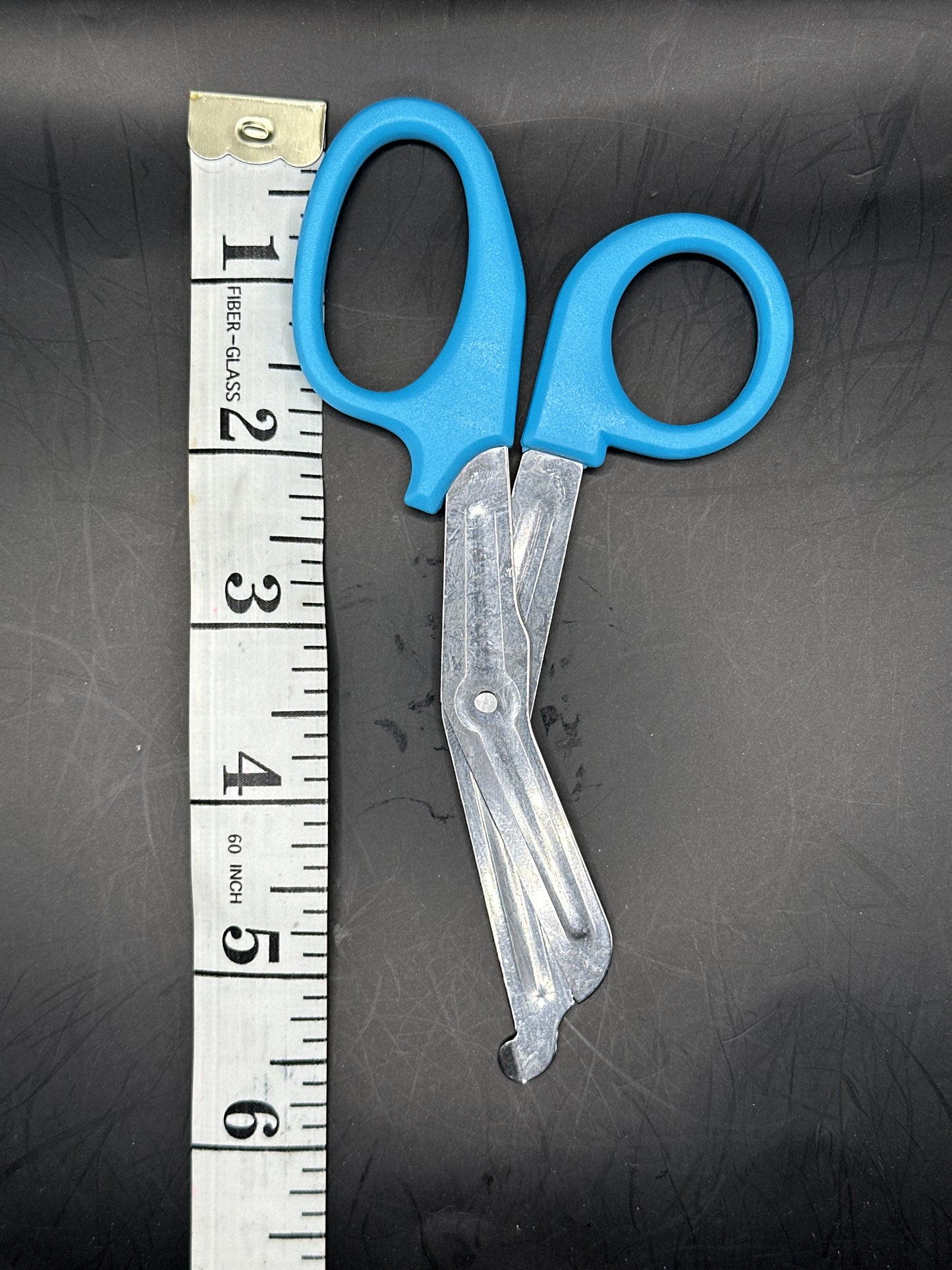 Emergency Scissors/Safety Shears: This Light Blue pair is 5.7" long, made with stainless steel and designed for first aid use to cut through thicker materials - it works on our rope, we tried it! 