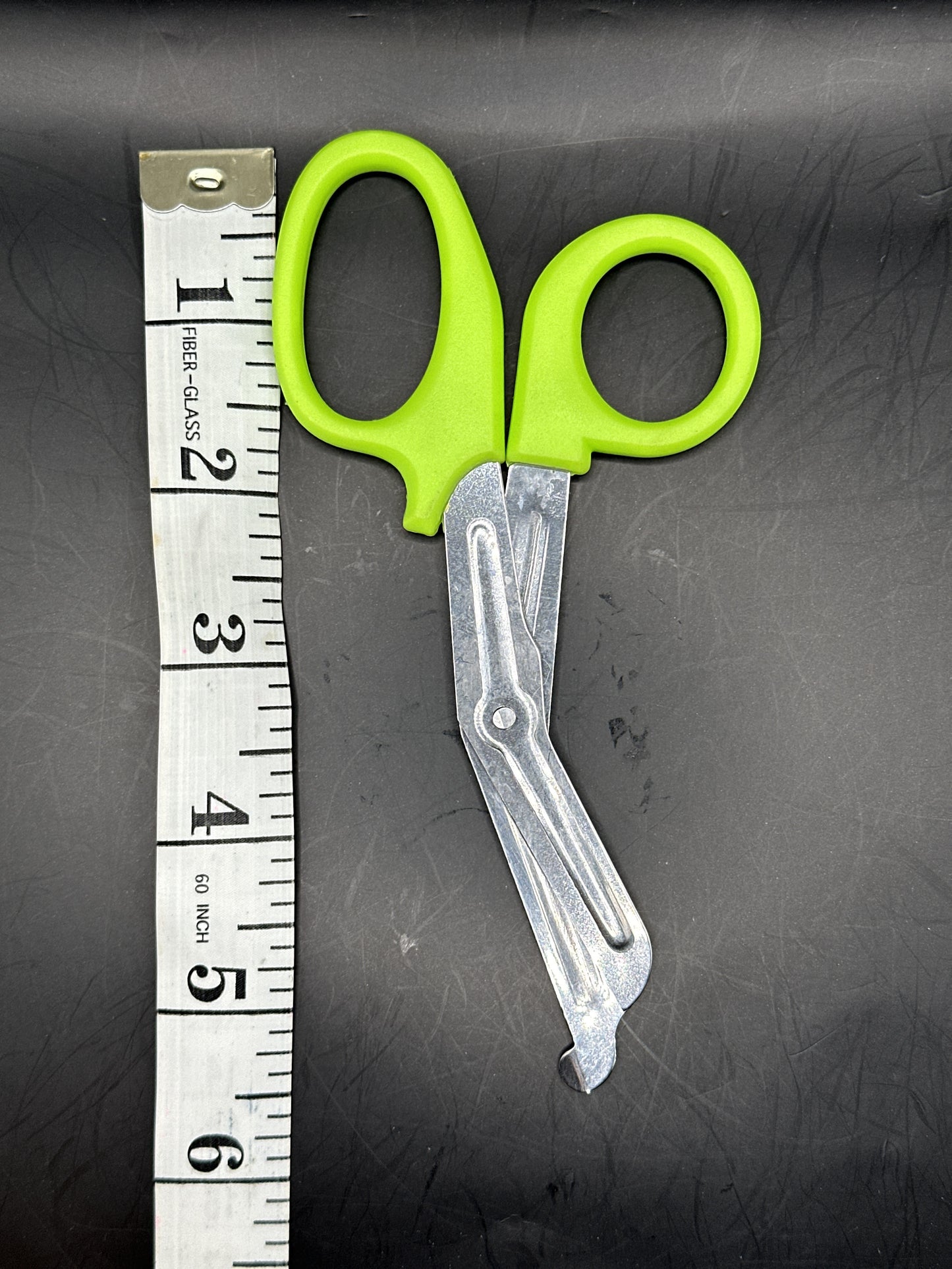 Emergency Scissors/Safety Shears: This Lime Green pair is 5.7" long, made with stainless steel and designed for first aid use to cut through thicker materials - it works on our rope, we tried it! 
