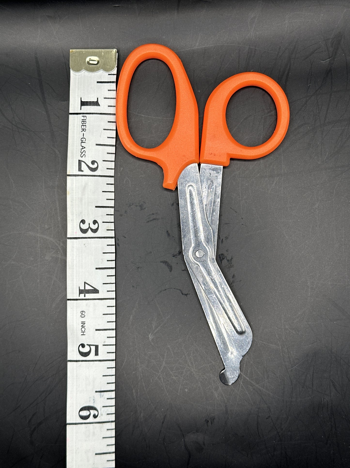 Emergency Scissors/Safety Shears: This Orange pair is 5.7" long, made with stainless steel and designed for first aid use to cut through thicker materials - it works on our rope, we tried it! 