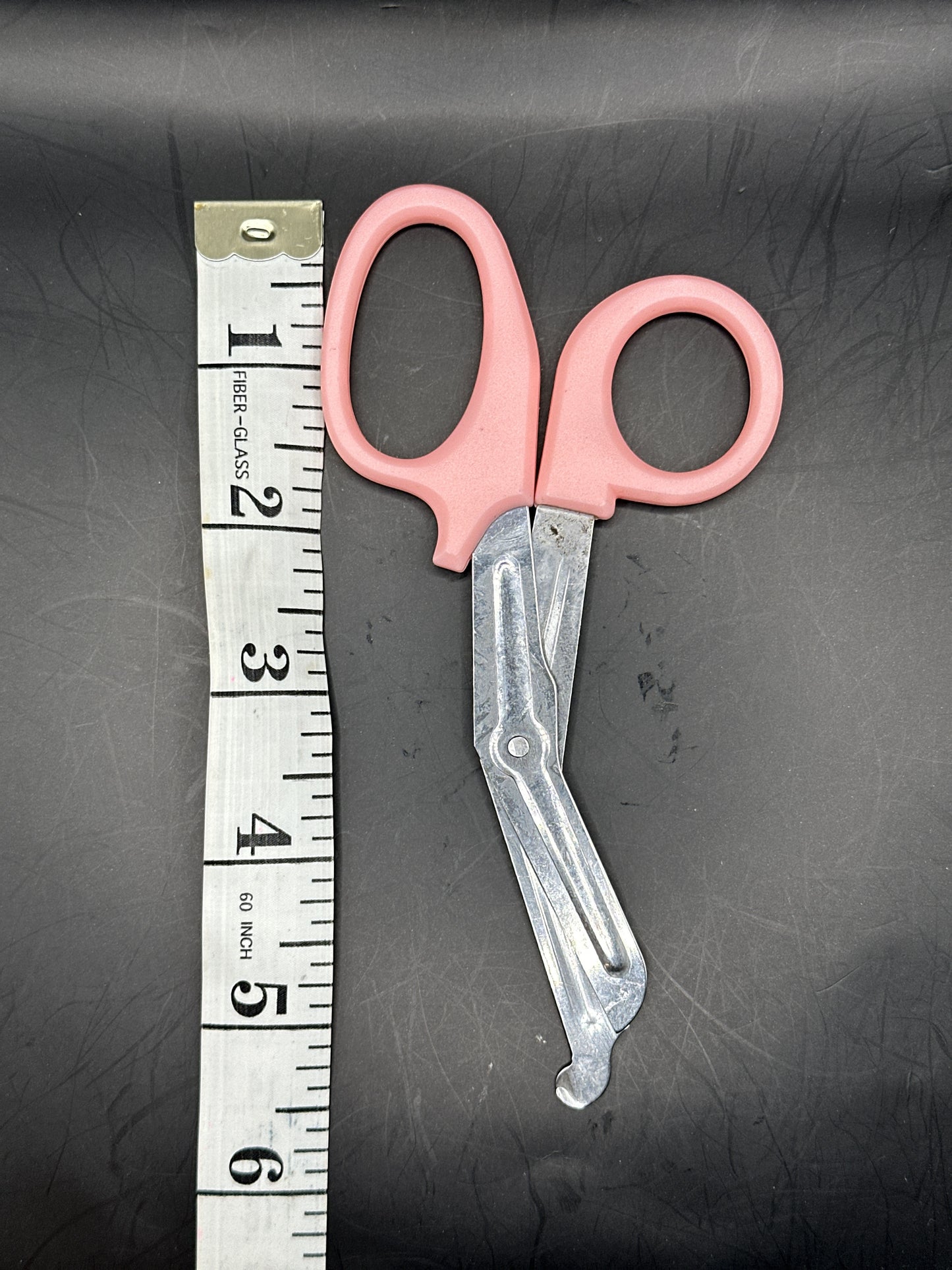 Emergency Scissors/Safety Shears: This Pink pair is 5.7" long, made with stainless steel and designed for first aid use to cut through thicker materials - it works on our rope, we tried it! 
