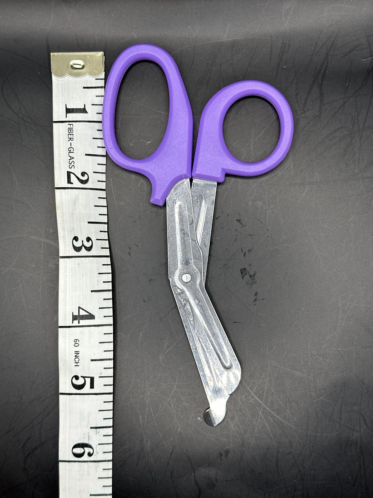 Emergency Scissors/Safety Shears: This Purple pair is 5.7" long, made with stainless steel and designed for first aid use to cut through thicker materials - it works on our rope, we tried it!