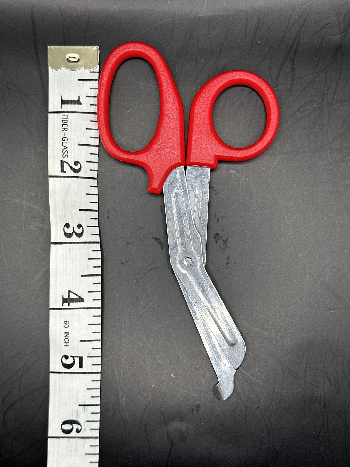 Emergency Scissors/Safety Shears: This Red pair is 5.7" long, made with stainless steel and designed for first aid use to cut through thicker materials - it works on our rope, we tried it!
